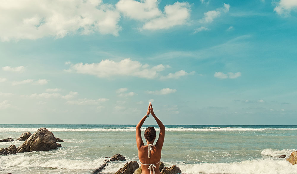 reversing-adrenal-fatigue-and-stress-woman-yoga-beach