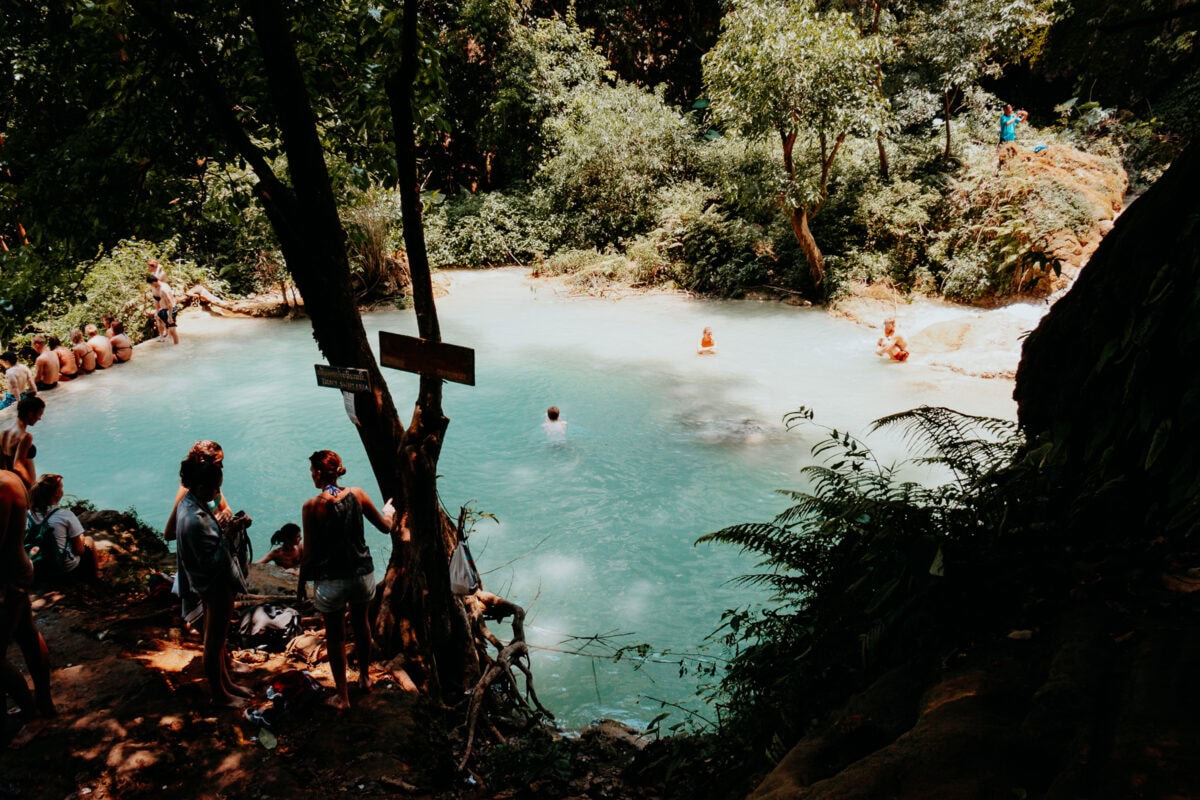 Menschen schwimmen in einer natürlichen blauen Lagune.