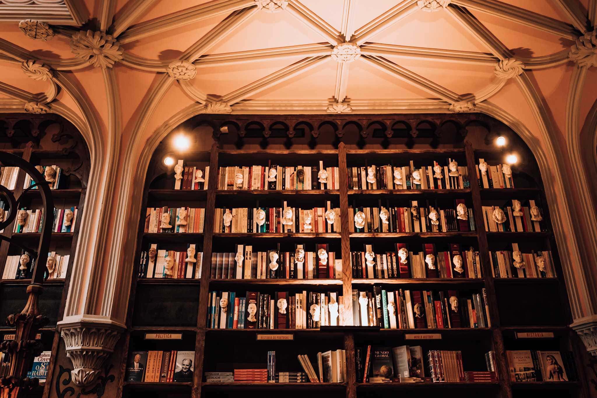 Bücherregal mit weißen Büsten von Schriftstellern in der Livraria Lello Porto Portugal