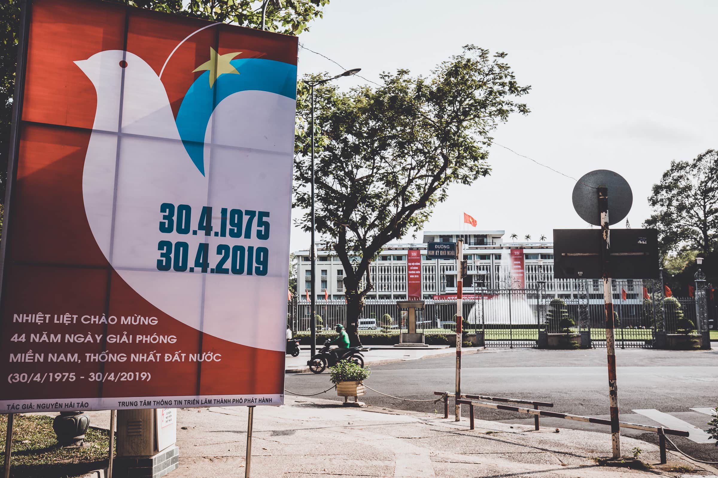 Propaganda poster end of war in front of Reunification Palace, Saigon, Vietnam
