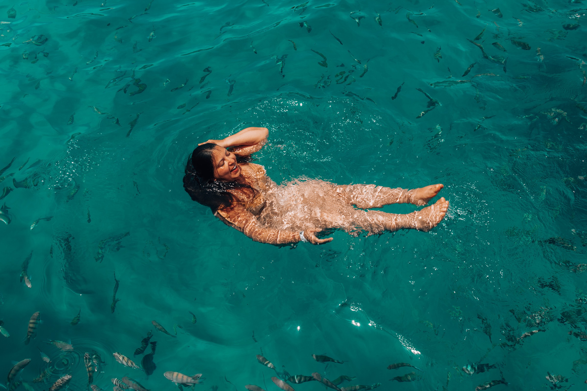 Baden zwischen Fischen in türkisblauem Meer