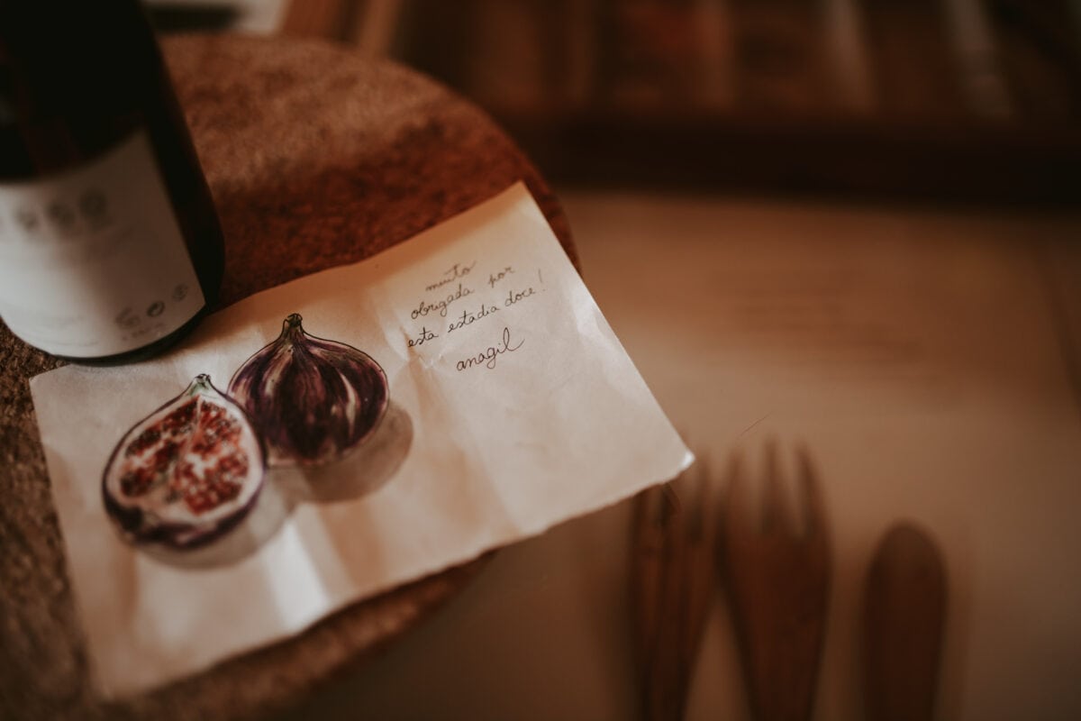 Handwritten note next to fig and wine bottle.
