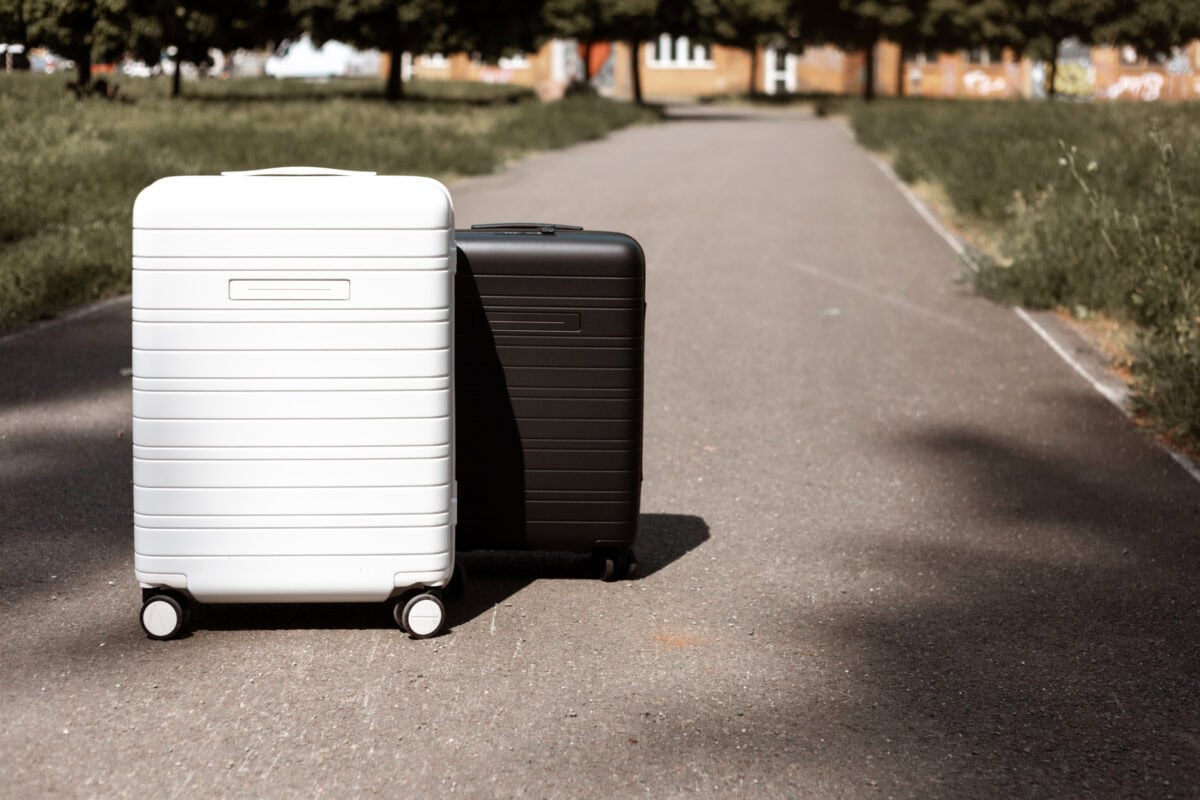 Zwei Koffer von Horizn Studios auf sonnigem Gehweg.