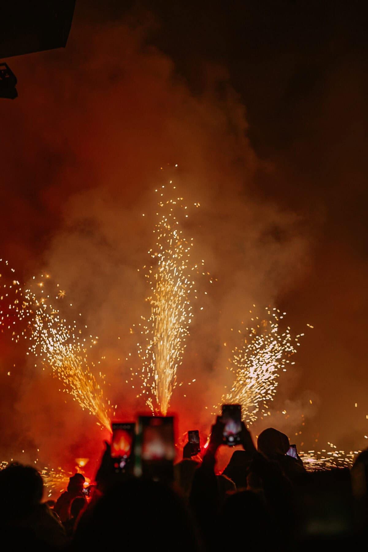 Feuerwerk und Menschen mit Smartphones im Dunkeln