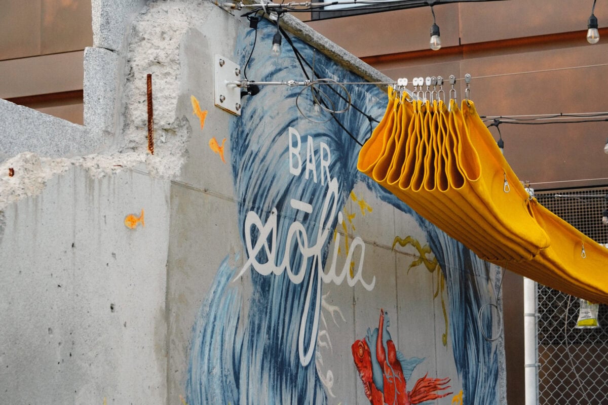 Graffiti und gelbe Struktur an Betonwand