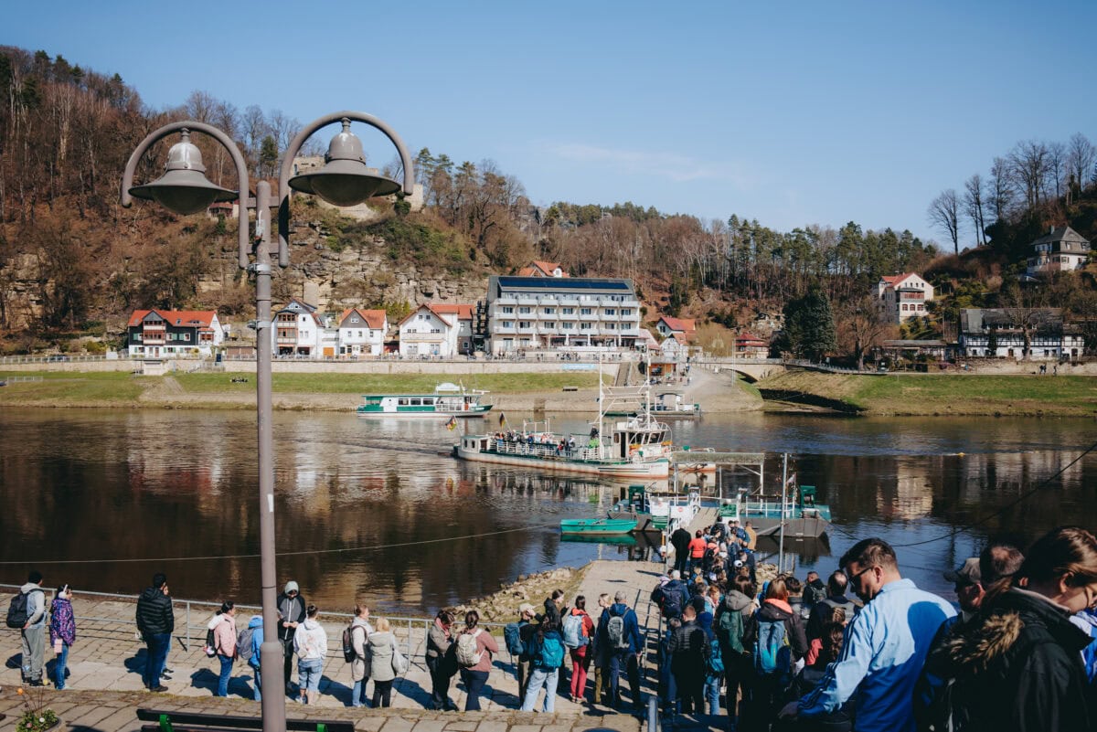People board ferry at riverside town