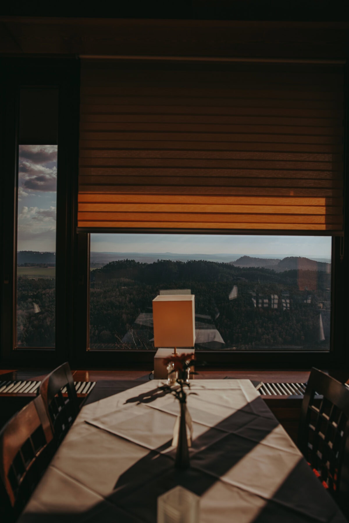 Dining table in front of panoramic window with mountain view