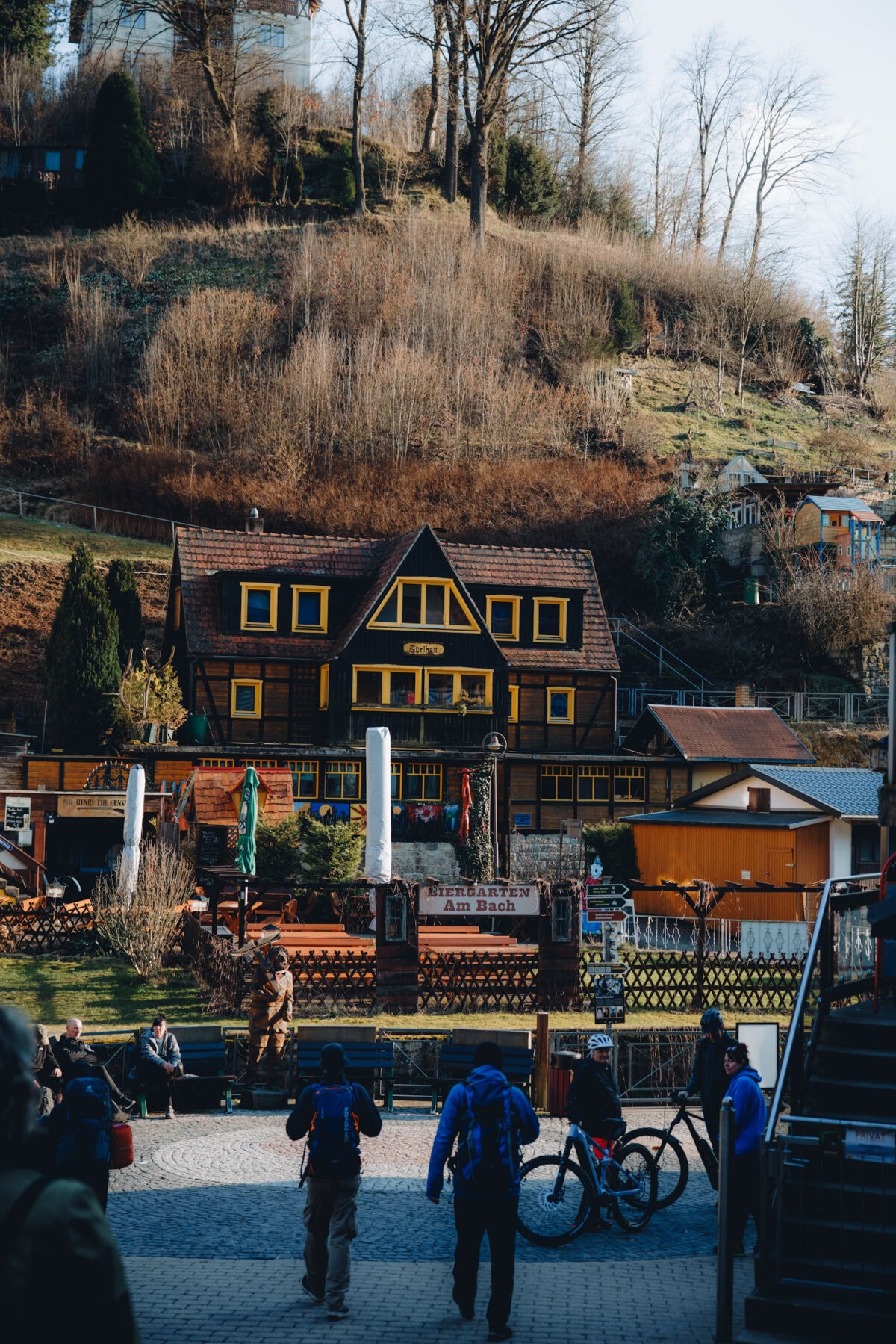 Beer garden with half-timbered house on a wooded slope