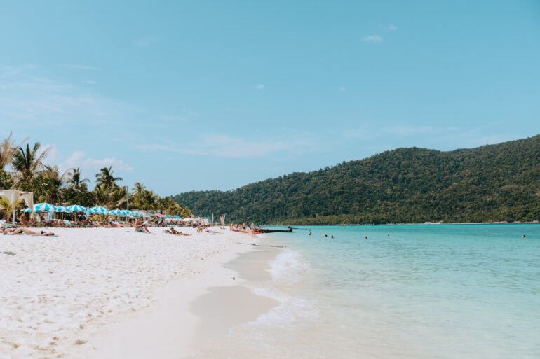 Tropical beach with turquoise sea and palm trees